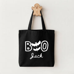 A black tote bag with the text "BOO Jack" printed on it, along with a ghost-shaped wooden hanger.
