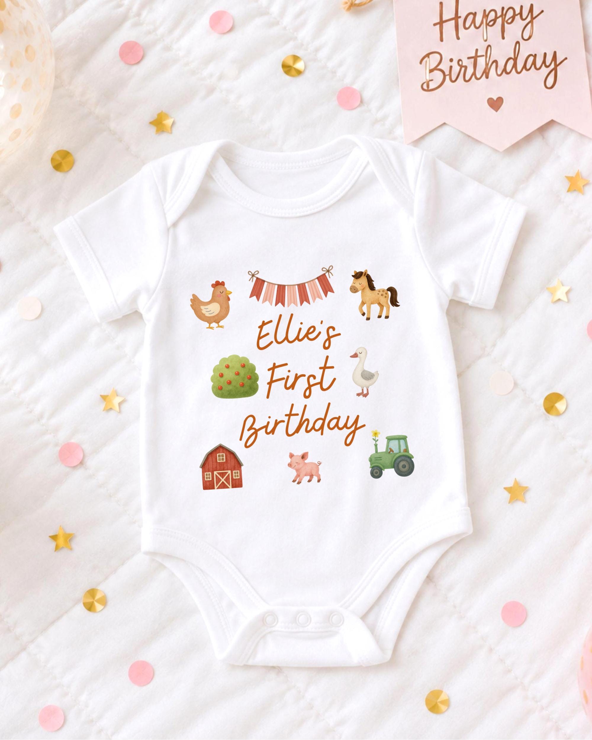A white baby onesie with a personalized birthday message printed on it, surrounded by confetti and a birthday card.