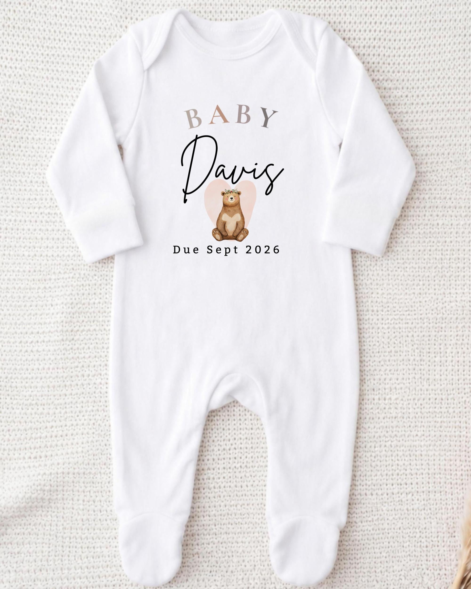 A white onesie with a personalized text and graphic design.