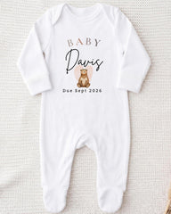 A white onesie with a personalized text and graphic design.