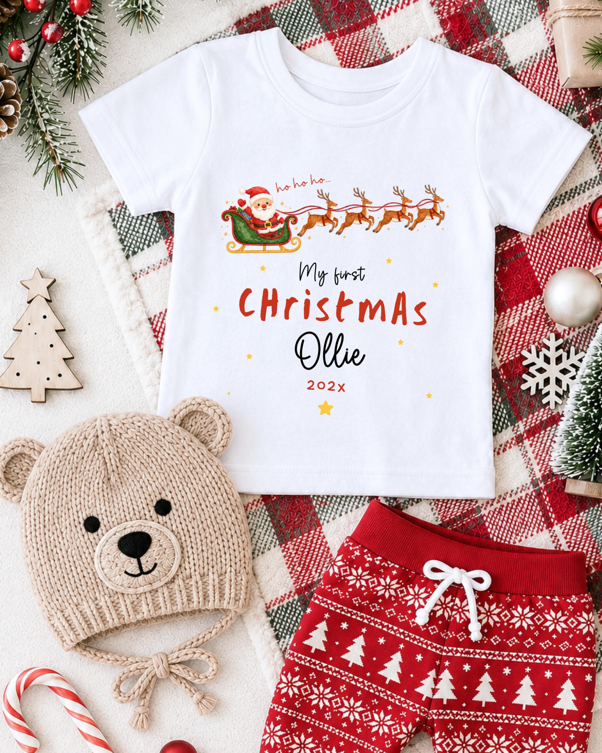 A white t-shirt with a Christmas-themed design, a beige knit hat with a teddy bear face, and red and white patterned shorts, all surrounded by Christmas decorations and ornaments.