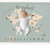 a baby is laying on a map of the world