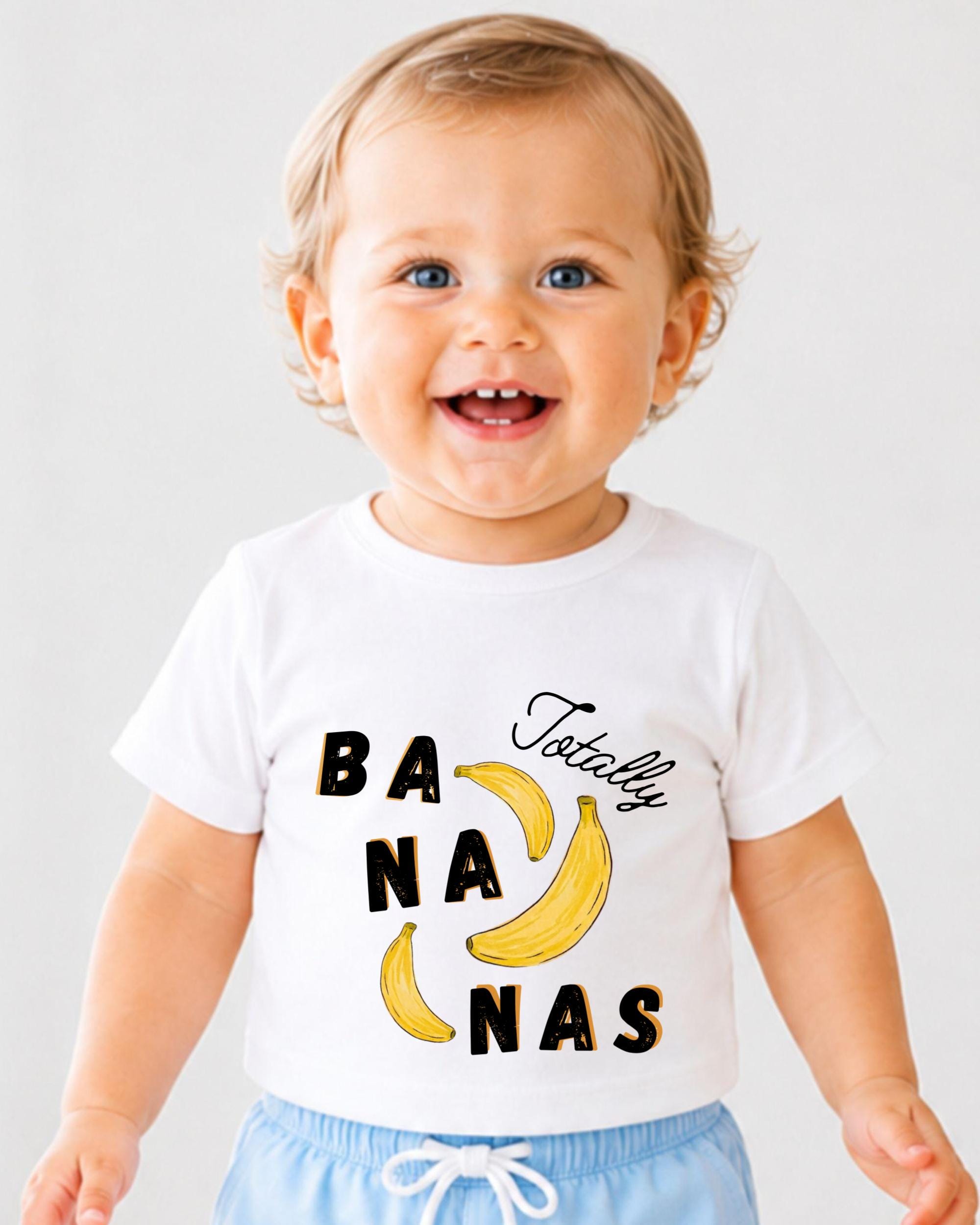 A smiling baby wearing a white t-shirt with the text "Totally Bananas" printed on it.