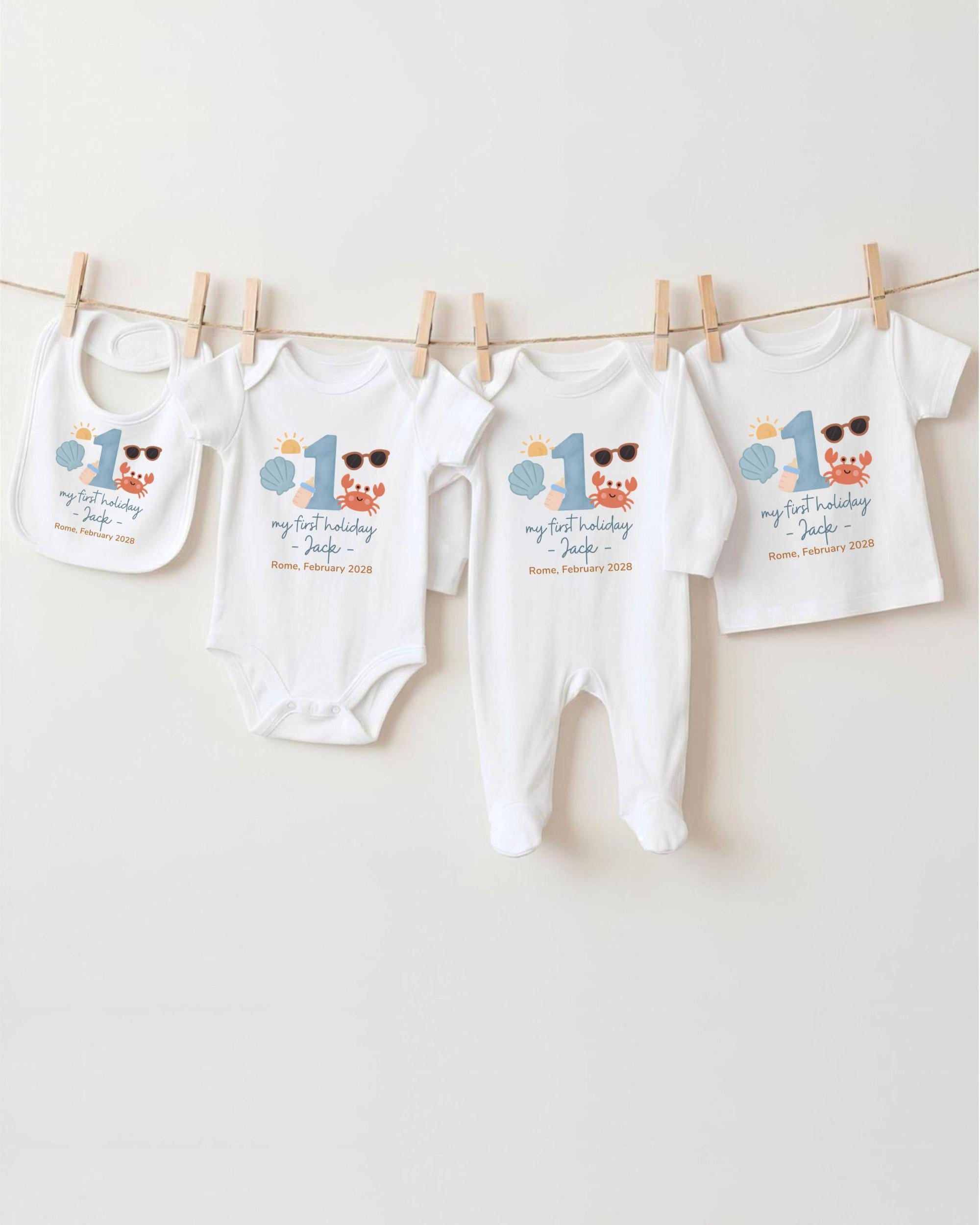A collection of baby clothes, including onesies and bibs, hanging on a clothesline.