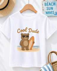 A white t-shirt with a cartoon image of a bear holding a surfboard and wearing sunglasses, along with the text "Cool Dude".