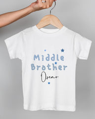 A white t-shirt with the text "Middle Brother Oscar" printed on it, along with blue stars.