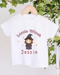 A white t-shirt with a cartoon image of a witch and the text "Little Witch Jessie" printed on it.