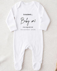 A white onesie with text printed on it, placed on a white background.
