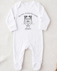 A white onesie with a black and white illustration of a dog's face and the text "My best friend has paws" printed on it.