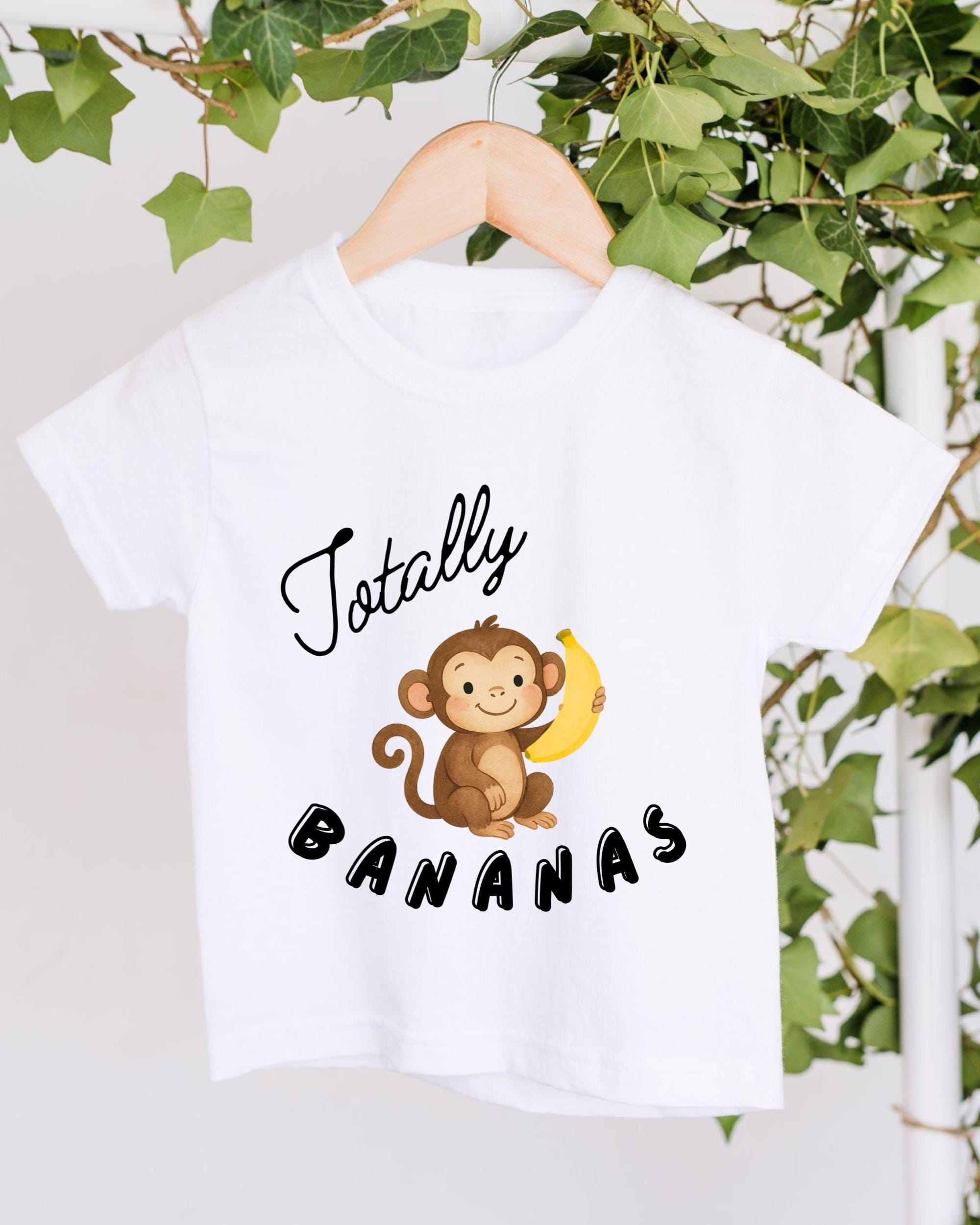 A white t-shirt with a cartoon monkey holding a banana and the text "Totally Bananas" printed on it.