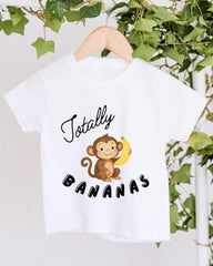 A white t-shirt with a cartoon monkey holding a banana and the text "Totally Bananas" printed on it.