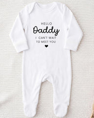 A white onesie with the text "Hello Daddy I can't wait to meet you" printed on it.
