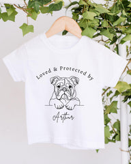 A white t-shirt with a graphic design of a bulldog and the text "Loved & Protected by Arthur" printed on it.