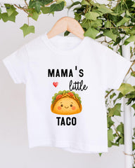 A white t-shirt with a graphic design of a taco and the text "Mama's little taco" printed on it.