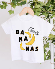 A white t-shirt with a graphic design featuring bananas and the text " Totally bananas" printed on it.