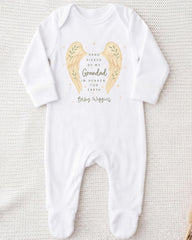 A white onesie with a design of two angel wings and a message about a grandfather in heaven.