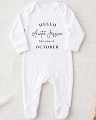 A white onesie with the text "Hello Auntie Jessica See you in October" printed on it.