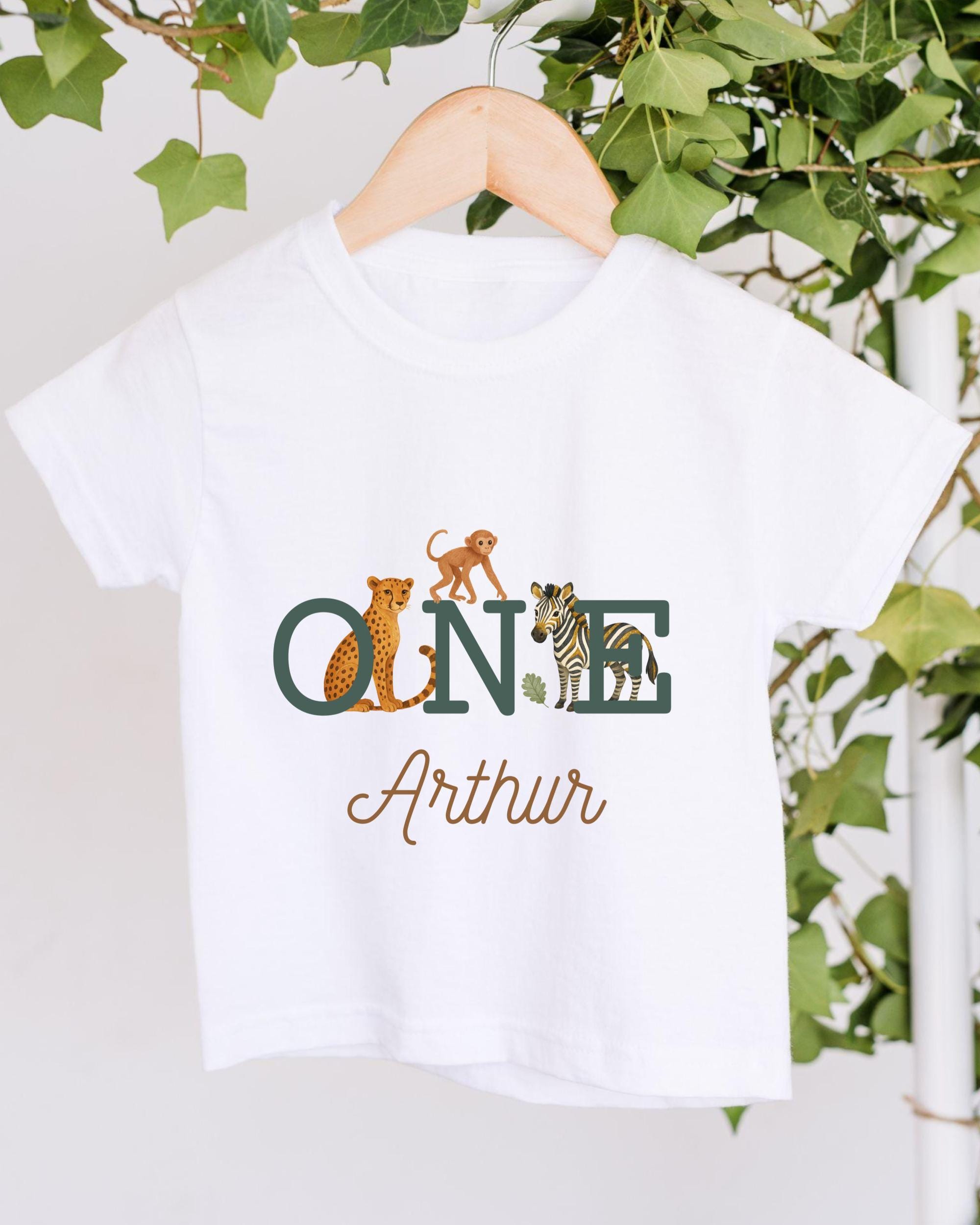 A white t-shirt with a graphic design featuring a monkey, zebra, and leopard, along with the text "ONE Arthur" printed on it.