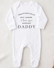 A white onesie with text printed on it.