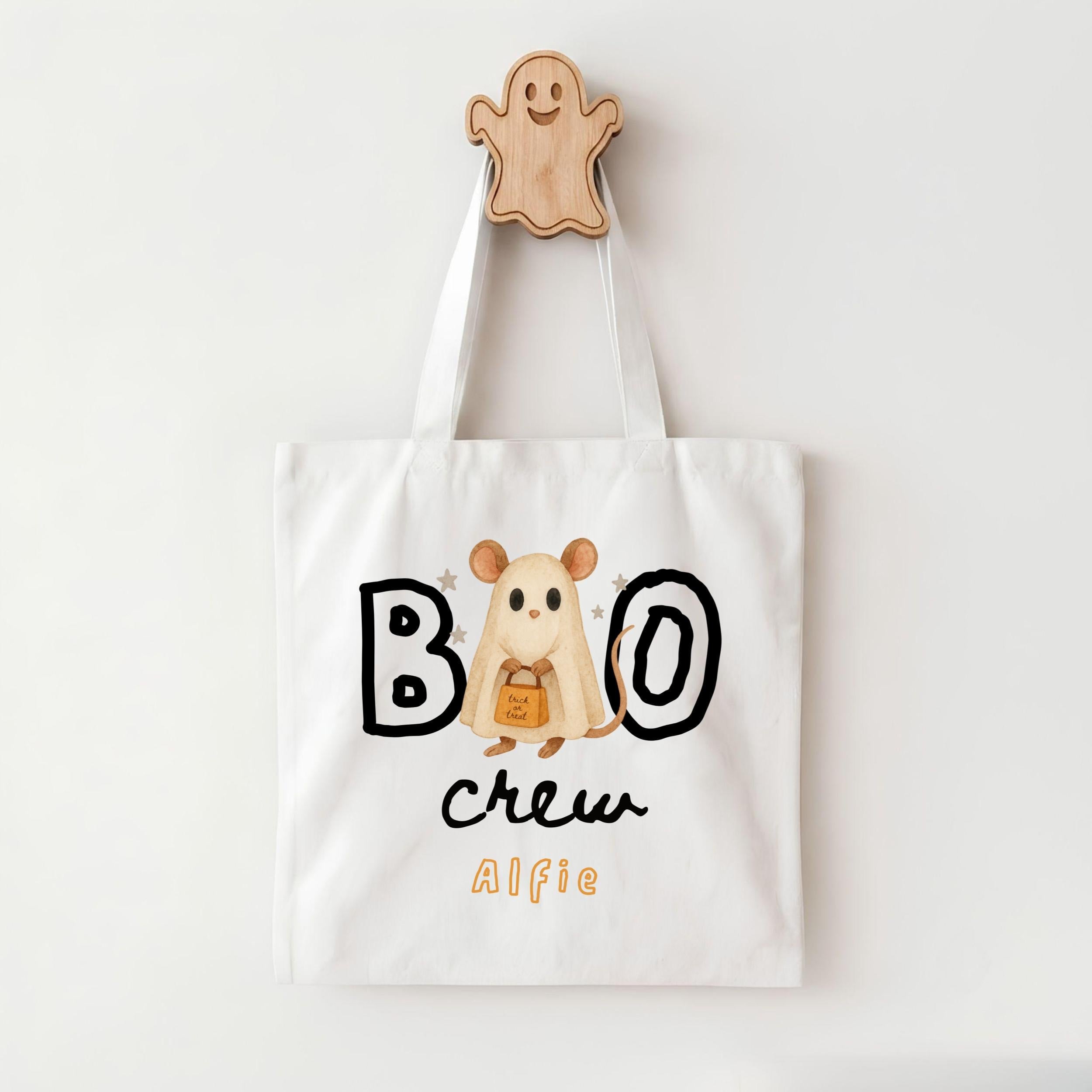 A white tote bag with a Halloween-themed design, featuring a ghost character and the text "BOO crew Alfie".