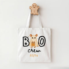 A white tote bag with a Halloween-themed design, featuring a ghost character and the text "BOO crew Alfie".