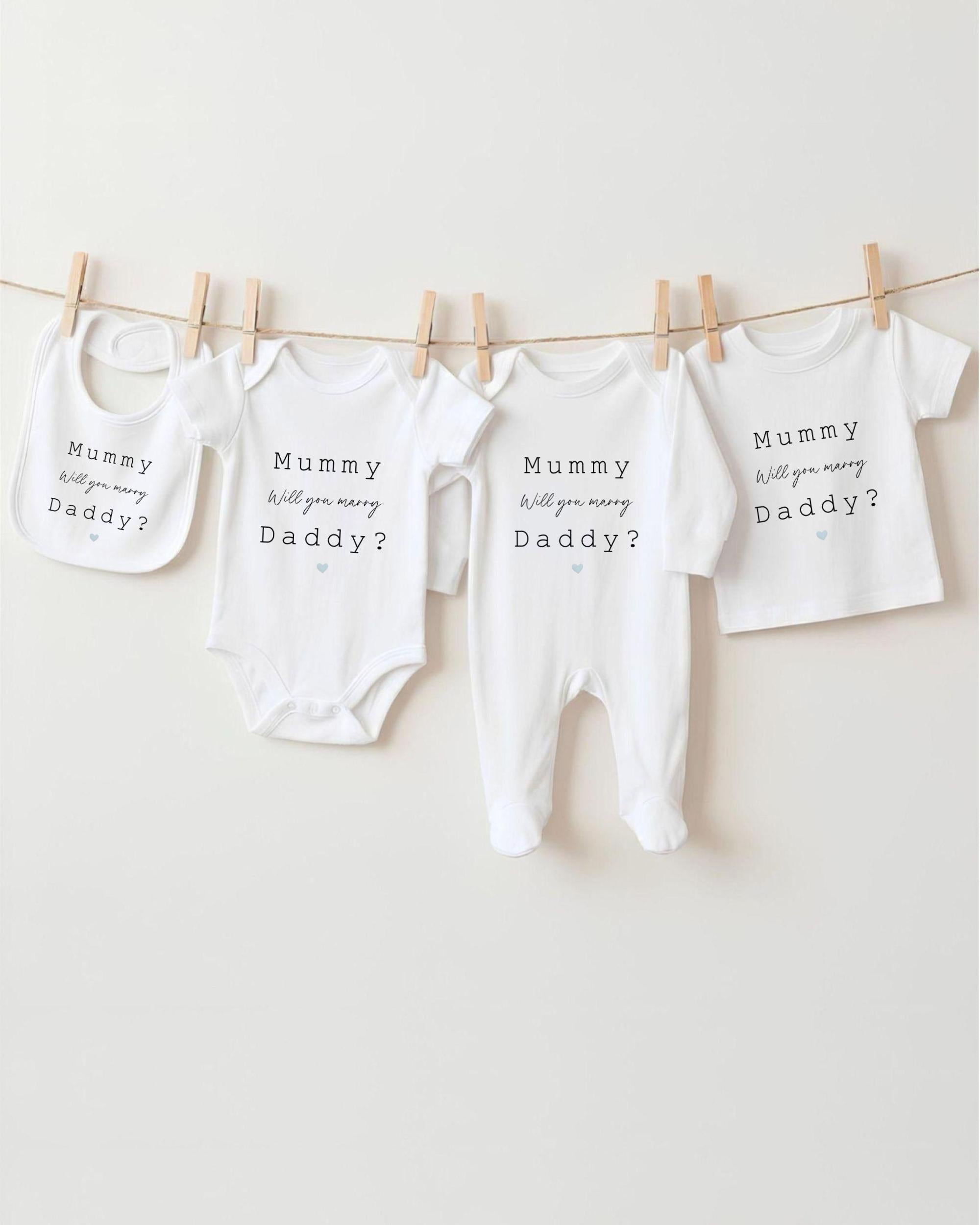 a collection of baby clothes hanging on a clothesline, with each piece featuring a different message related to the concept of a "mummy will you baby Daddy?".