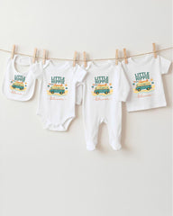 A collection of baby clothes, including onesies and bibs, hanging on a clothesline.