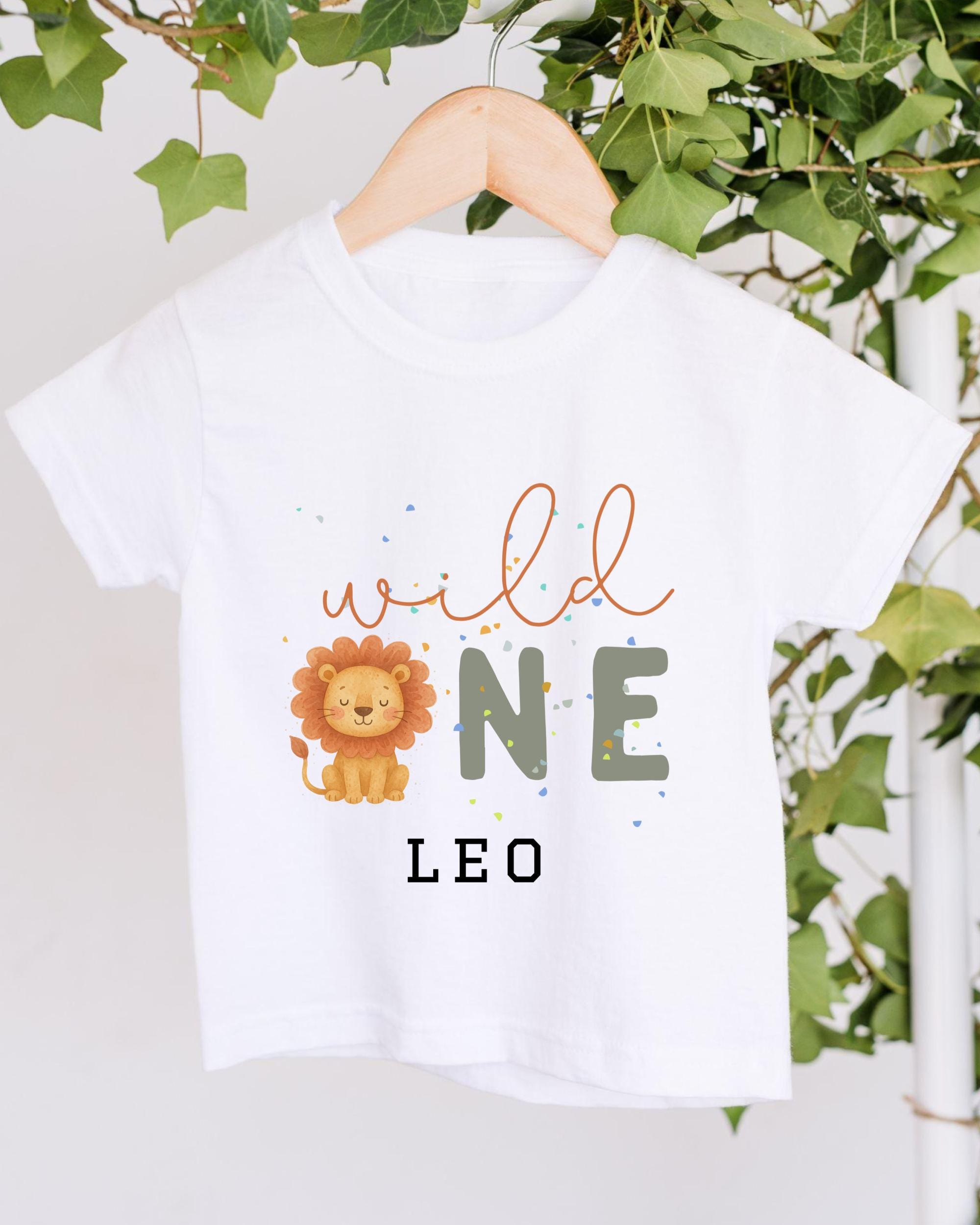 A white t-shirt with a printed design featuring a lion and the text "wild one leo" printed on it.