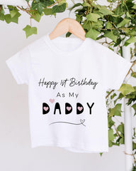 A white t-shirt with text and graphics hanging on a wooden hanger, with greenery in the background.