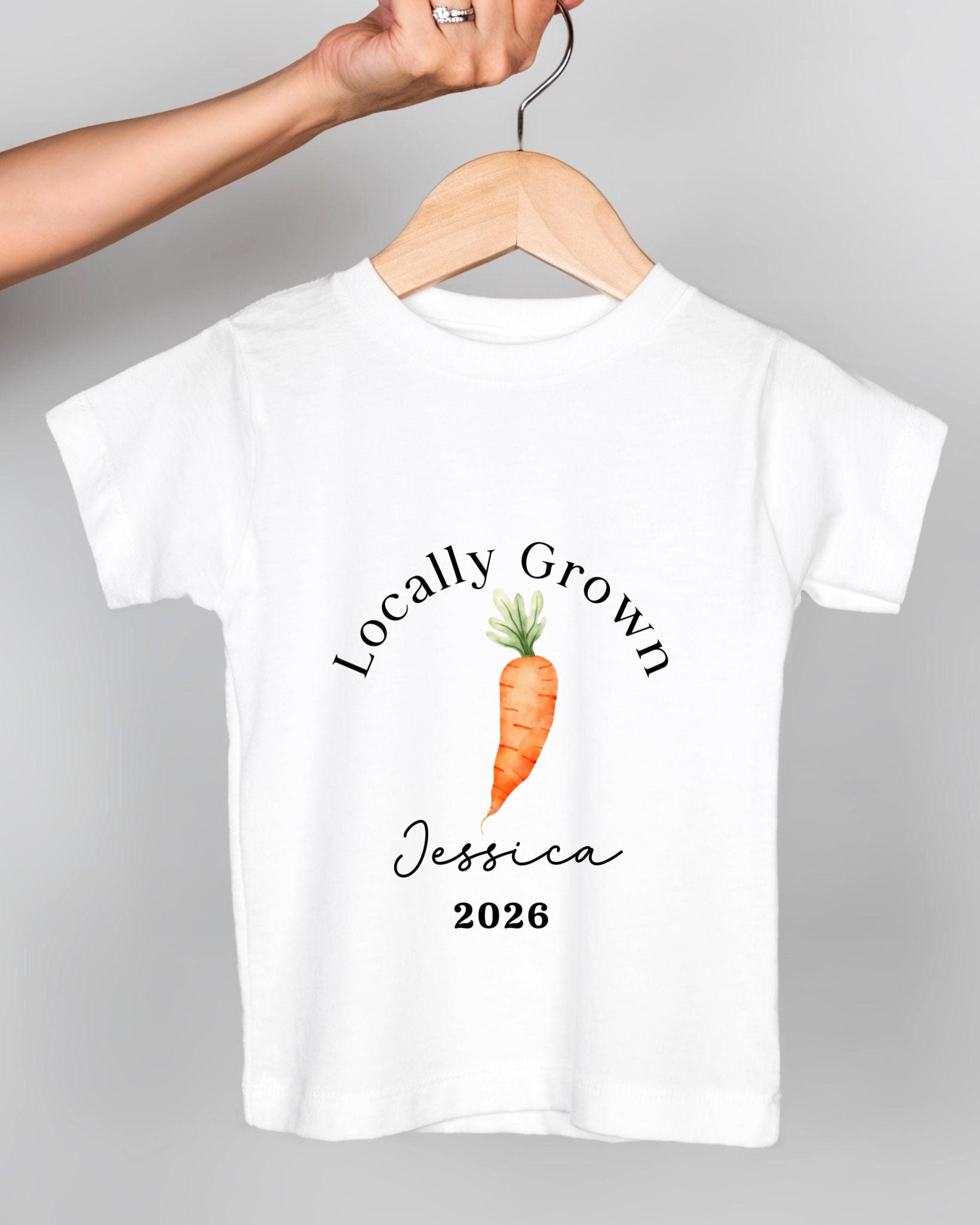 A white t-shirt with a printed design of a carrot and the text "Locally Grown Jessica 2016" printed on it.