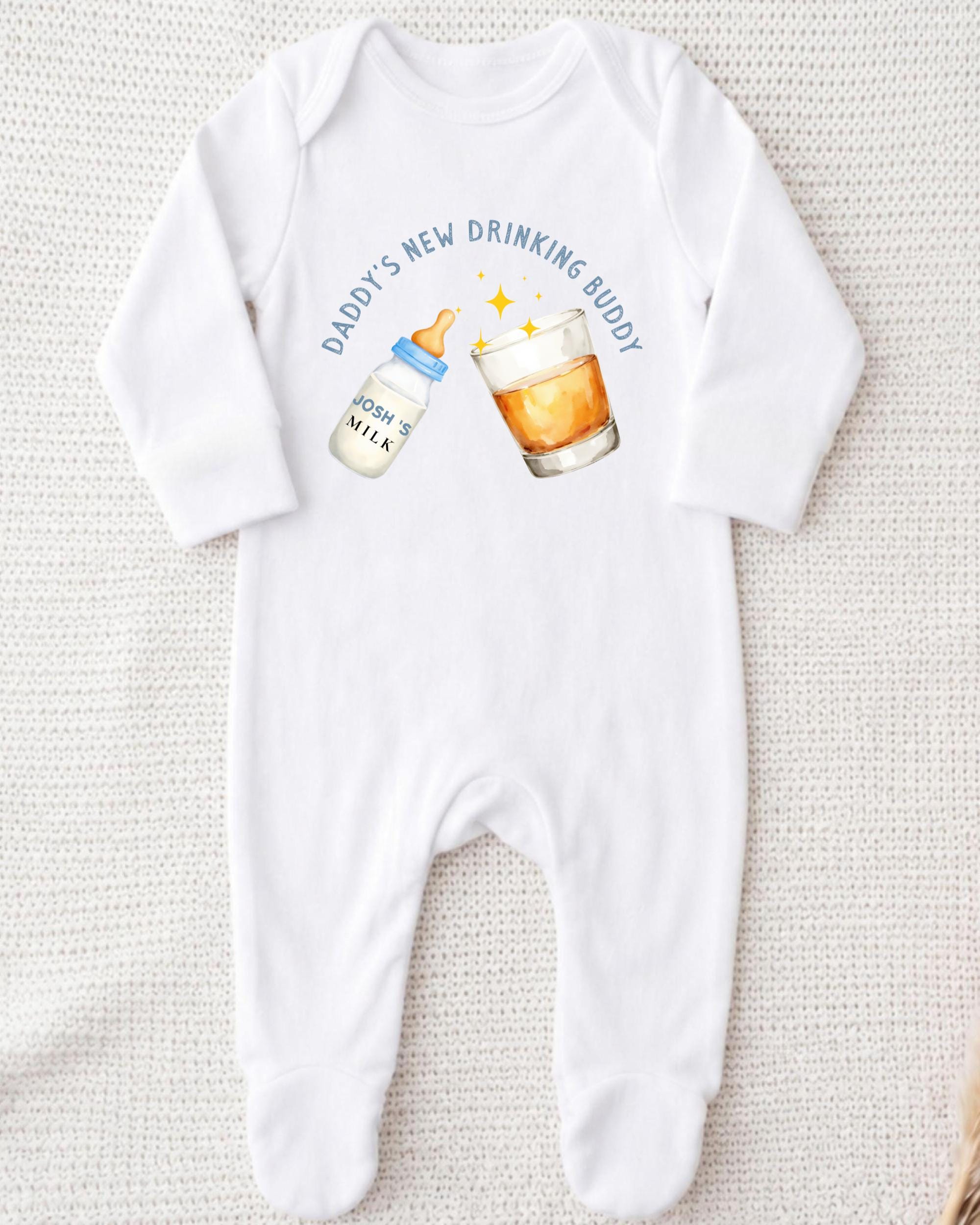 A white onesie with a graphic design on it, depicting a bottle of baby milk and a glass of beer.