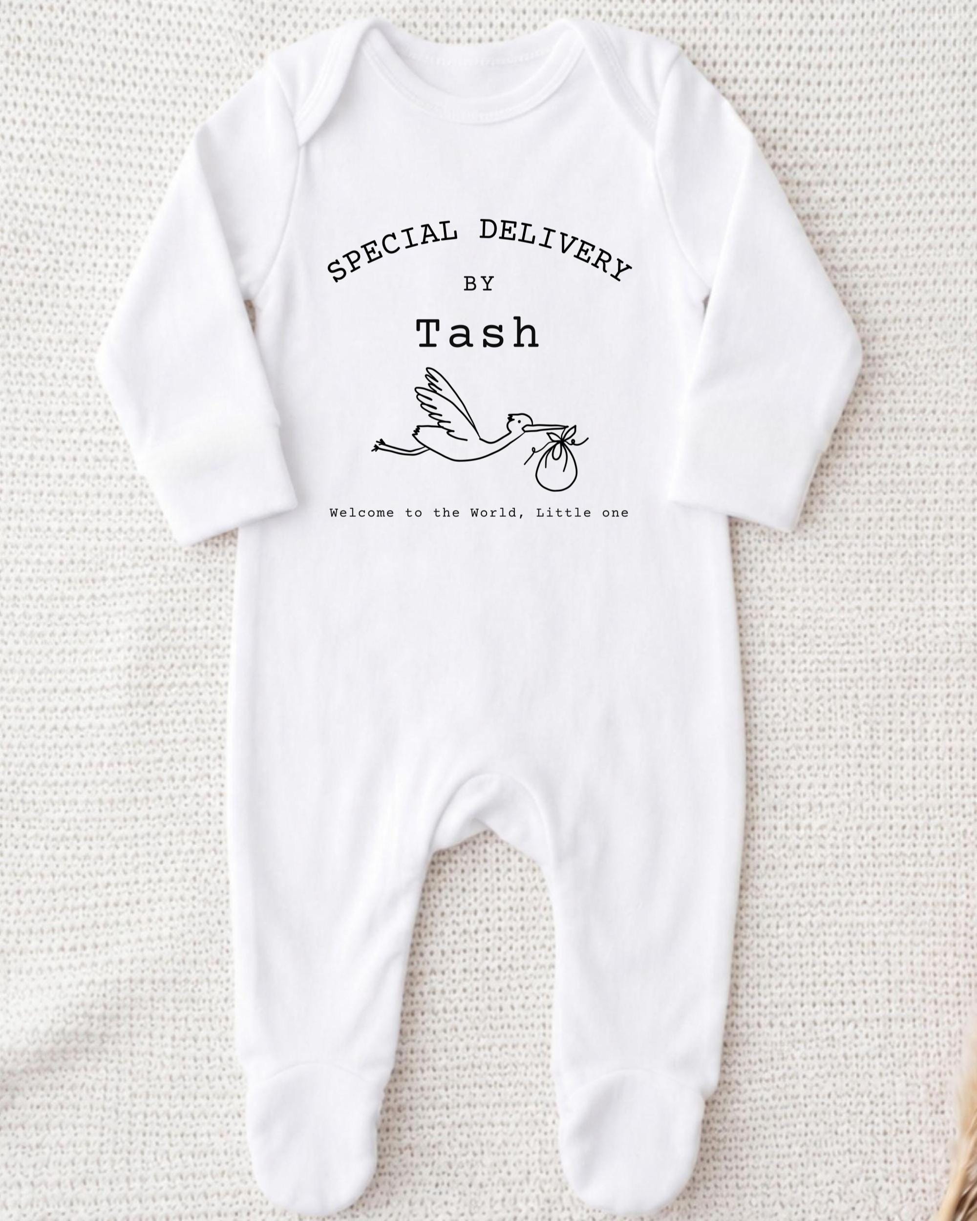 A white onesie with text and a graphic of a baby swan.