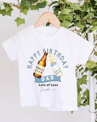 A white t-shirt with a graphic design featuring a bottle of beer and a baby bottle, along with the text "Happy Birthday Dad Lots of Love Josh".