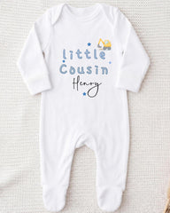 A white onesie with blue text and a small construction vehicle graphic printed on it.