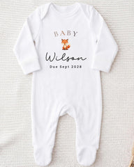 A white onesie with the text "BABY Wilson Due Sept 2008" printed on it, along with an illustration of a fox.