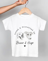 A white t-shirt with a graphic design featuring two dog faces and the text "Loved & protected by Bruno & Hugo" printed on it.