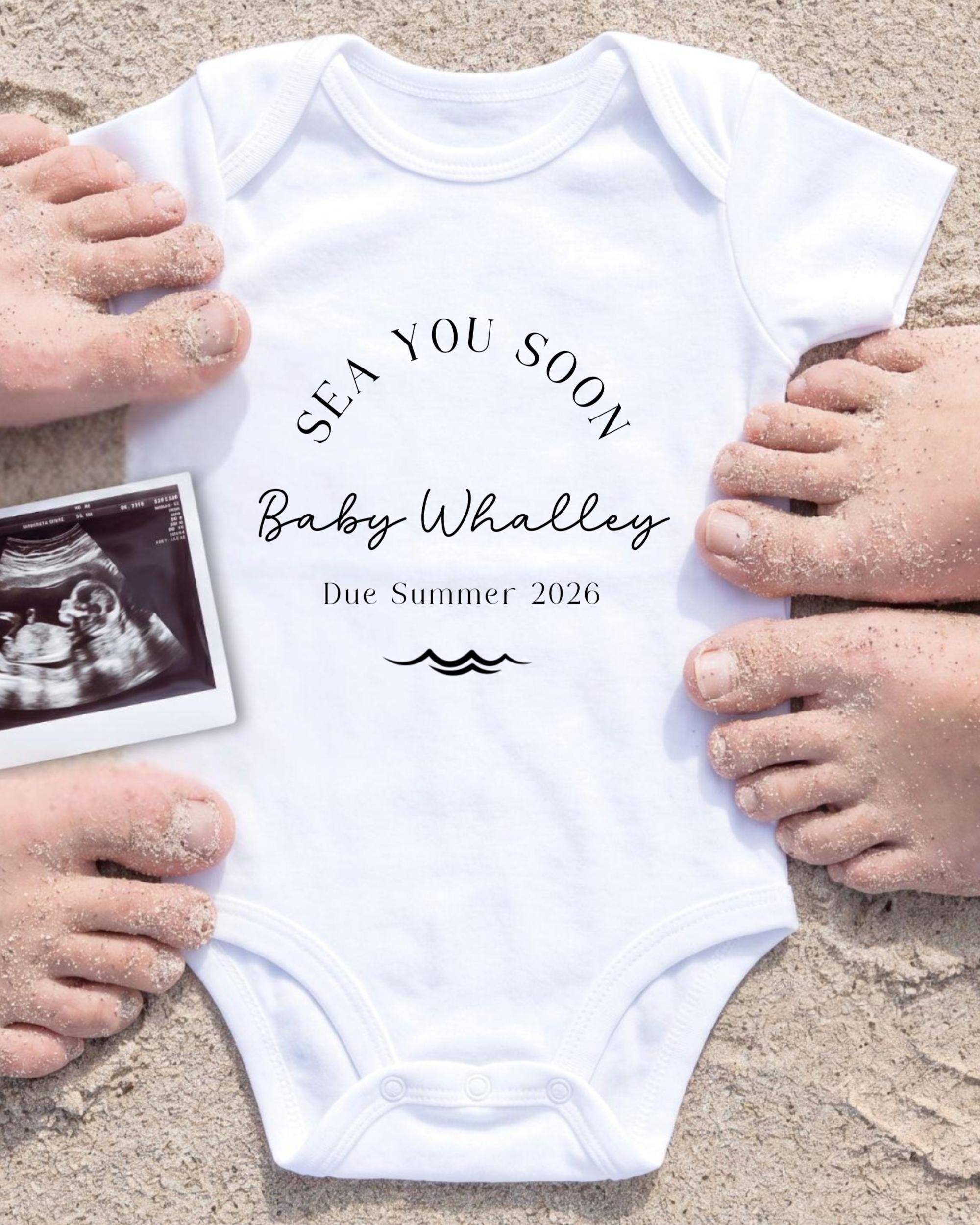 A white onesie with the text "SEA YOU SOON Baby Whalley Due Summer 2026" printed on it, along with an image of an Ultrasound scan of a baby's belly.