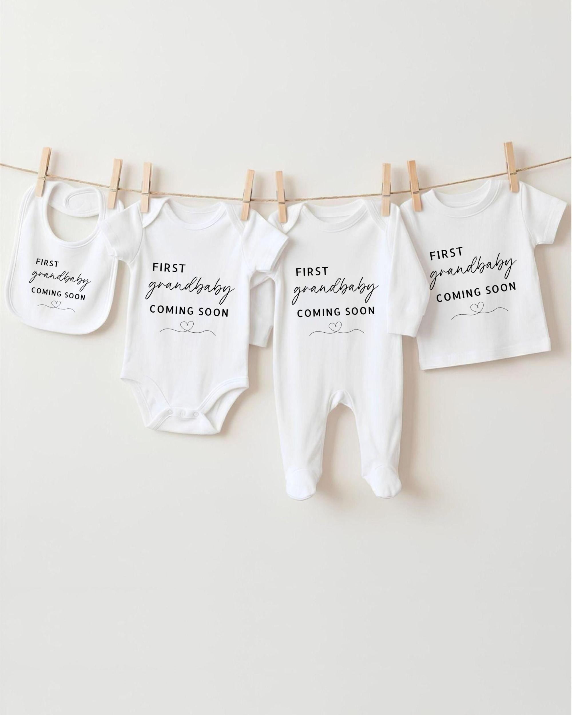a collection of baby clothes hanging on a clothesline, each with a unique message about the upcoming arrival of a grandbaby.