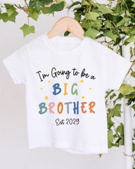 A white t-shirt with text that says "I'm Going to be a BIG BROTHER" and "Est 2029" printed on it.