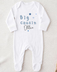 A white onesie with blue text and stars printed on it.