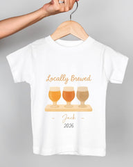 A white t-shirt with a graphic design featuring three beer glasses and the text "Locally Brewed Jack 2026".