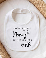 A white bib with black text that reads "HAND PICKED BY MY NANNY IN HEAVEN FOR earth".