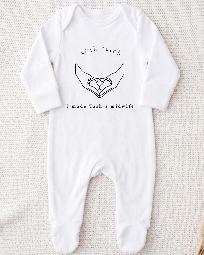 A white bodysuit with a graphic design and text printed on it.