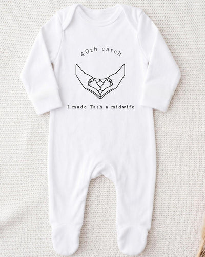 A white bodysuit with a graphic design and text printed on it.