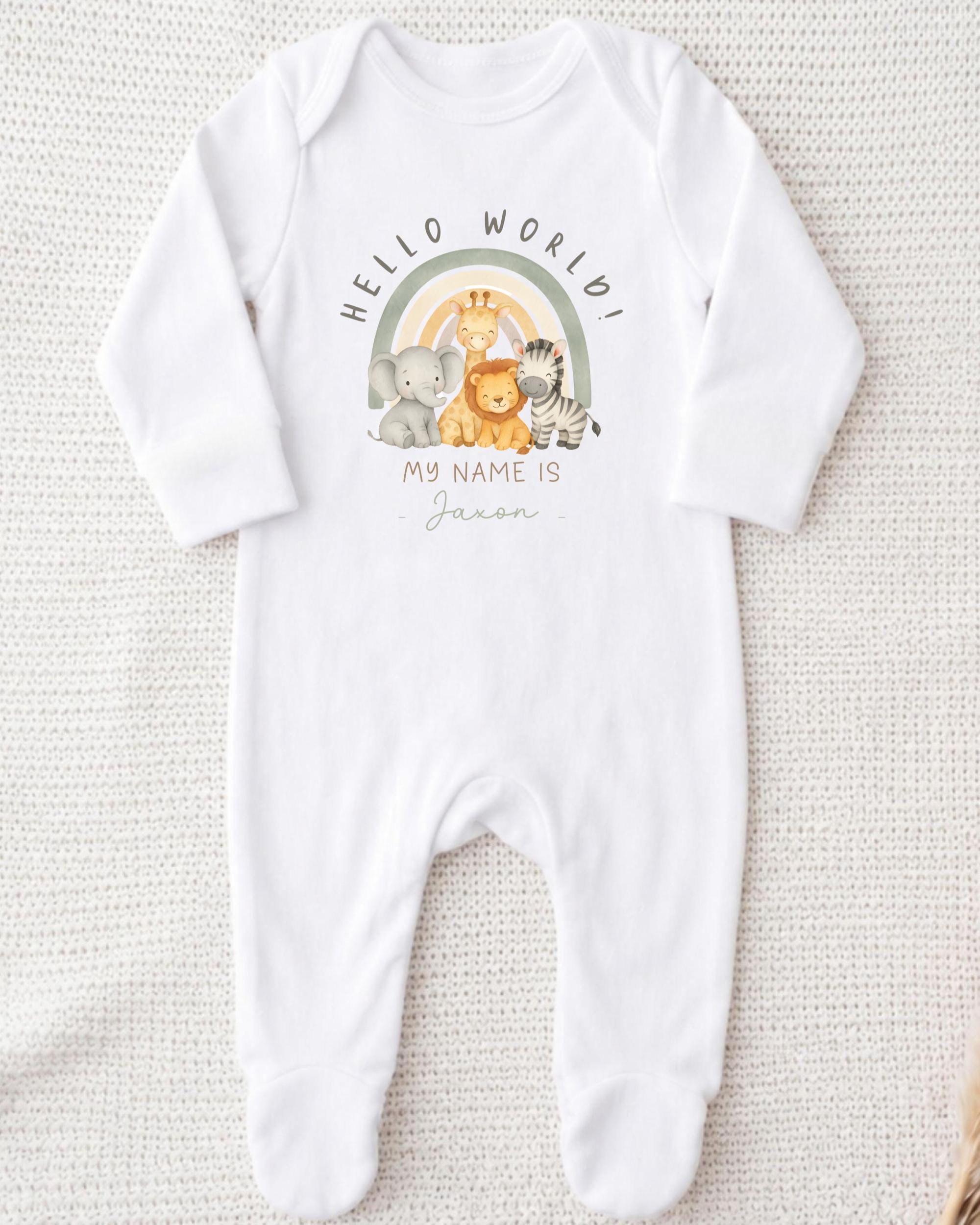 A white onesie with a graphic design featuring a rainbow and various animals, including a giraffe, lion, and zebra. The text on the onesie says "Hello World!" and "My name is [Name]".