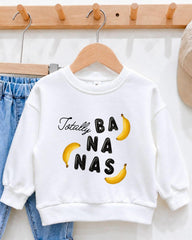 A white sweatshirt with the text "Totally BANANA" printed on it, along with two yellow bananas.
