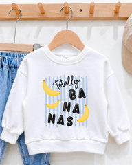 A white sweatshirt with a playful graphic design featuring bananas and the text "Totally BANANA" printed on it.