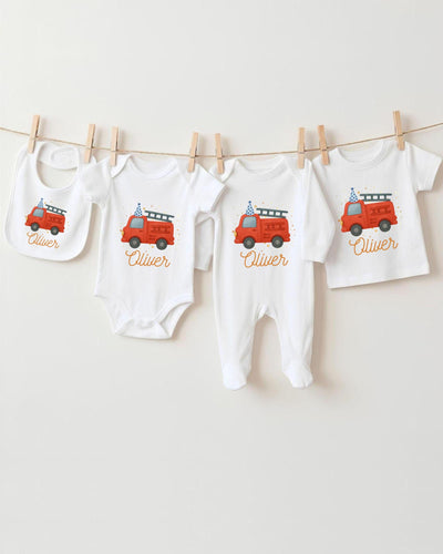 A collection of baby clothes and bibs featuring a red fire truck design, with the name "Olivier" printed on them.