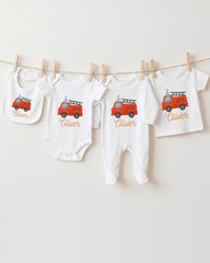 A collection of baby clothes and bibs featuring a red fire truck design, with the name "Olivier" printed on them.