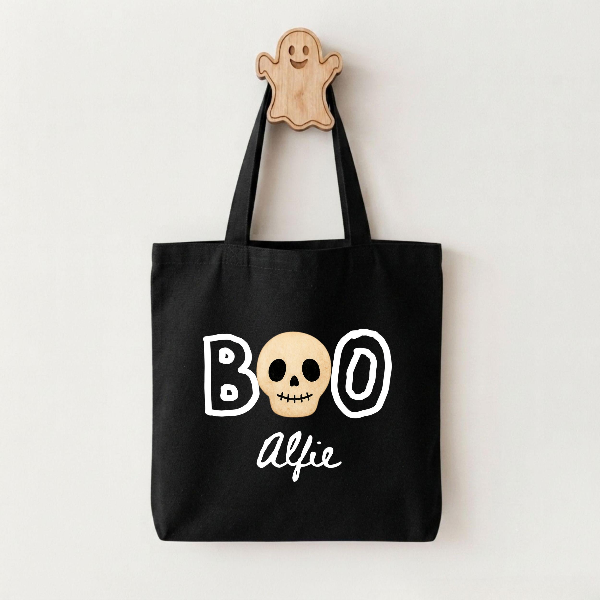 A black tote bag with the text "BOO ALFIE" printed on it, along with a skull graphic.